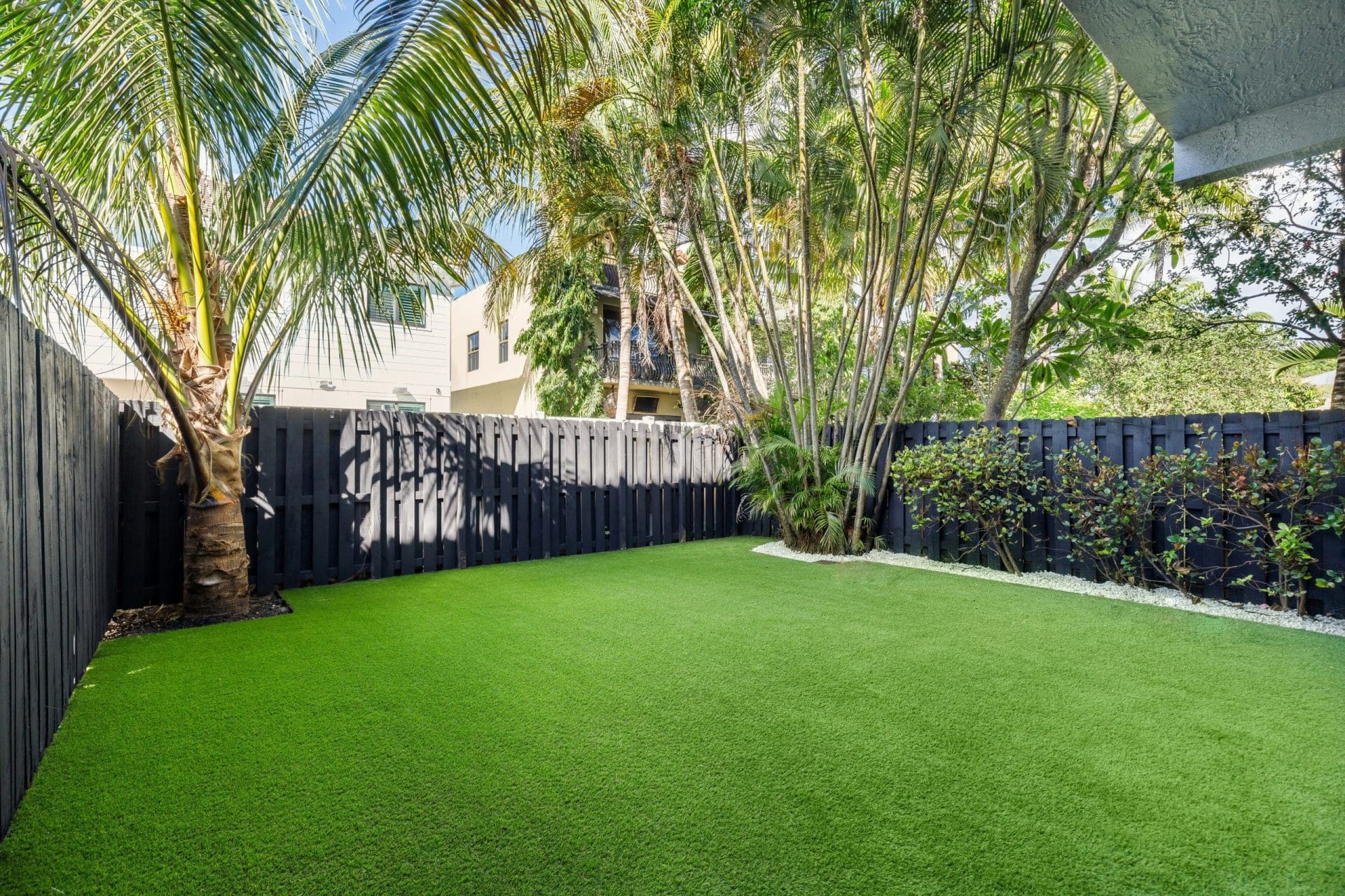 Patio,With,Artificial,Grass,,Fenced,With,Wooden,Fences,,Flowerbed,With lawn care