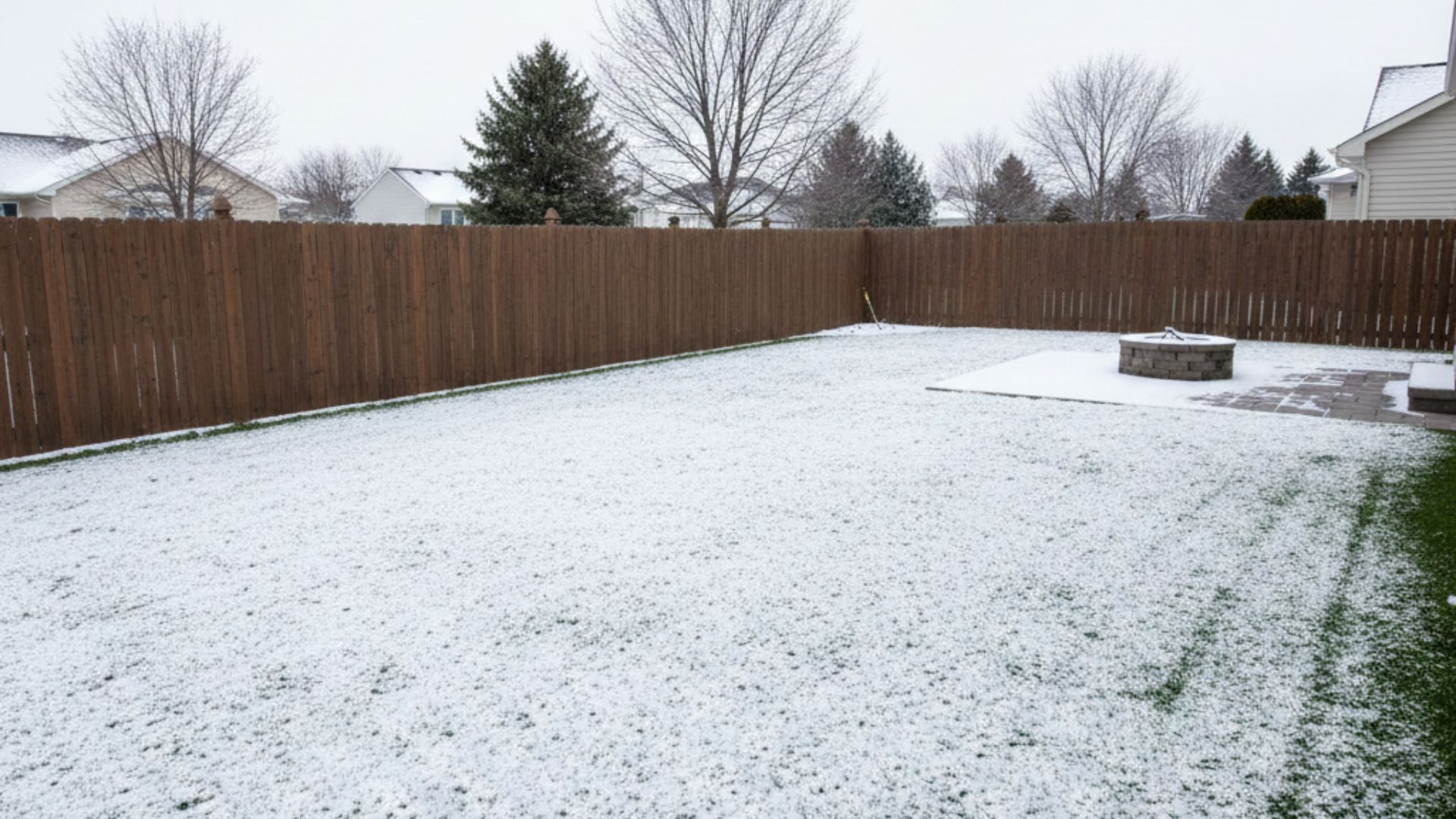Artificial turf lawn in Maumee, Ohio lightly covered with snow in winter.